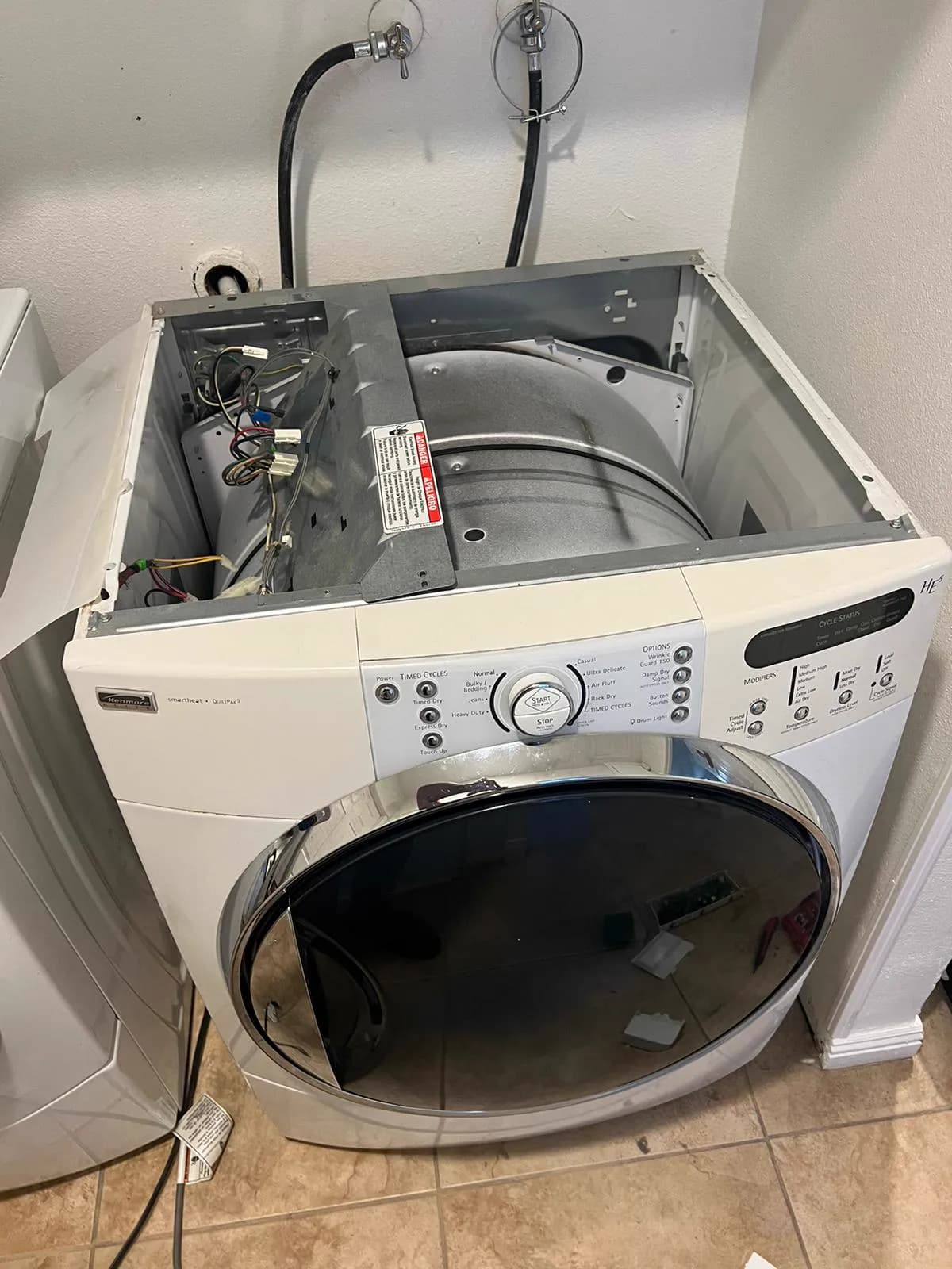 Front-load washer with the top panel removed during a repair
