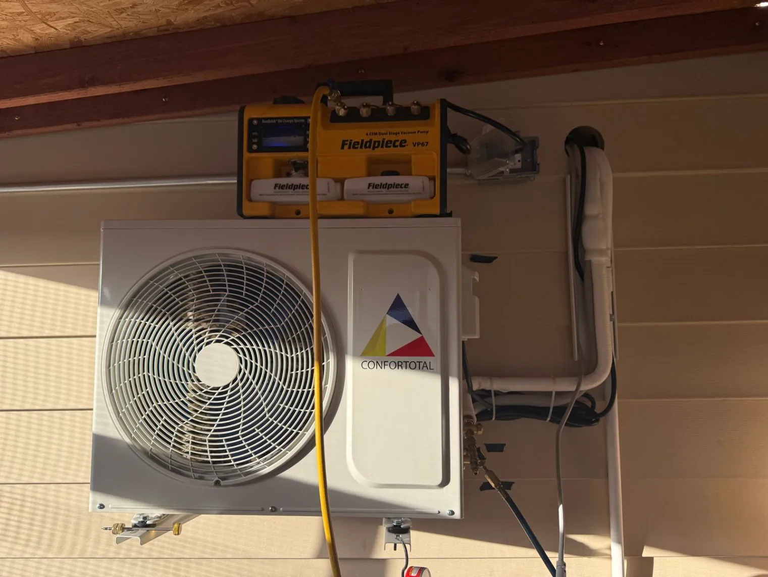 Mini-split outdoor unit on an exterior wall during a service call